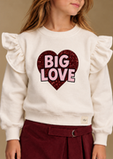 RG1793 ivory girls’ sweatshirt, close-up of Big Love heart print, ruffles and fabric.