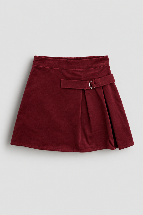 RG1801 bordo ince fitilli kadife kız çocuk etek, 3–9 yaş; ön görünüm, pile ve metal halka detayı.