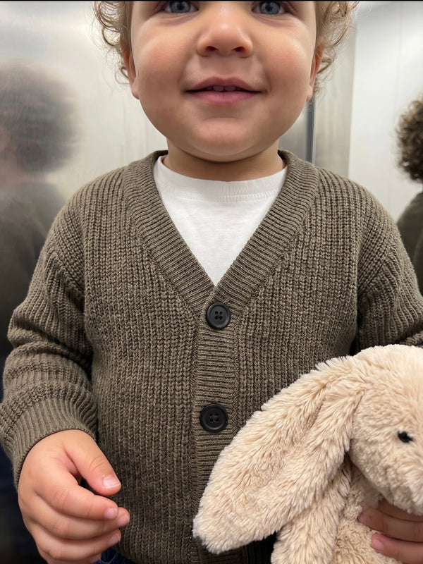 Haki V yaka düğmeli Selanik triko hırka giyen bebek, tavşan oyuncağıyla yakın görünüm | RG397