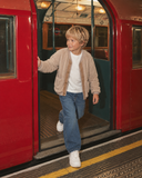 Taş RG1780 düğmeli peluş çocuk hırkası, kırmızı metro kapısında yürüyen model