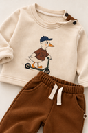 RG415 baby outfit detail showing the duck print, shoulder buttons and waistband and fabric of the brown trousers.